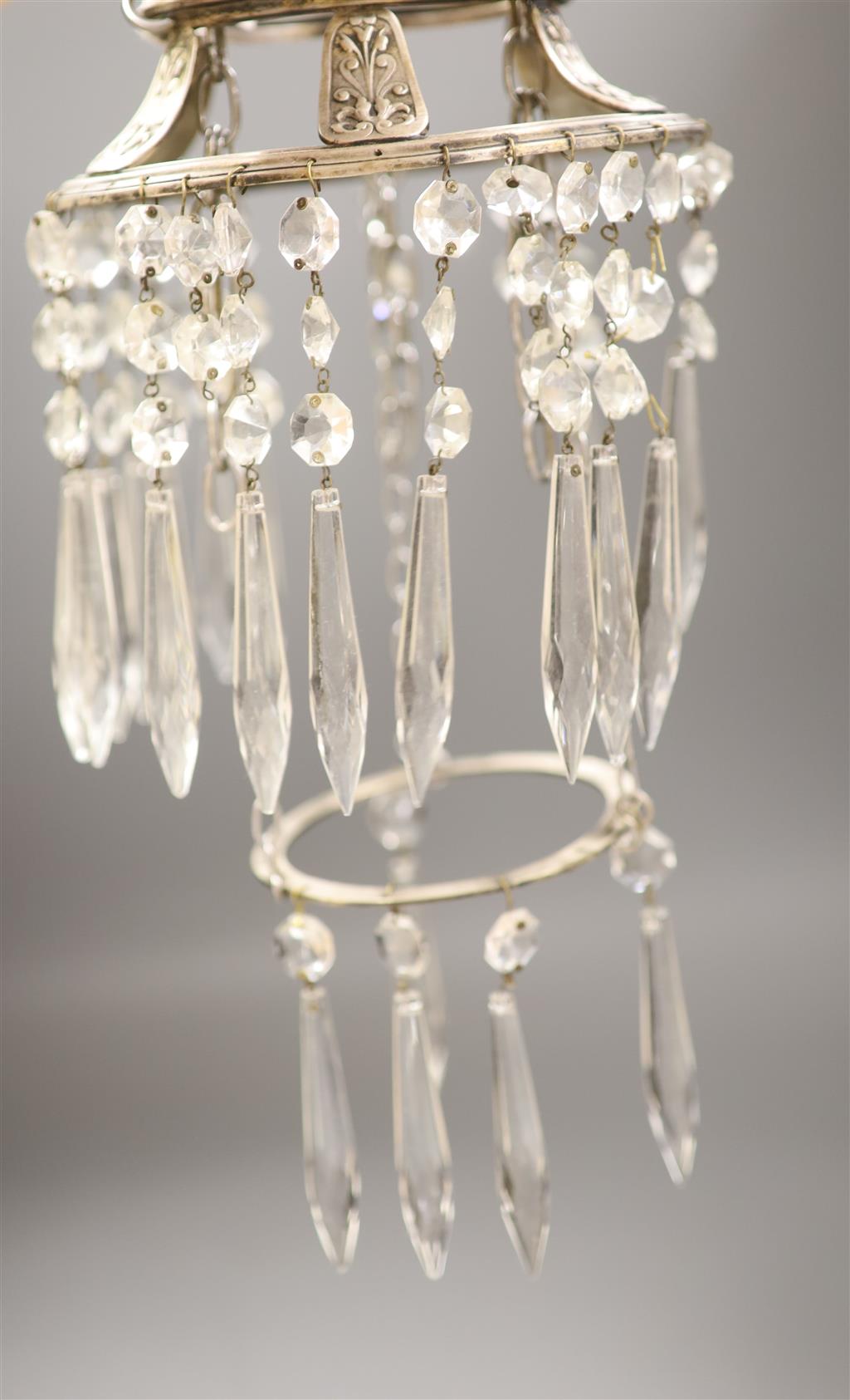 A plated ceiling light hung with clear glass drops